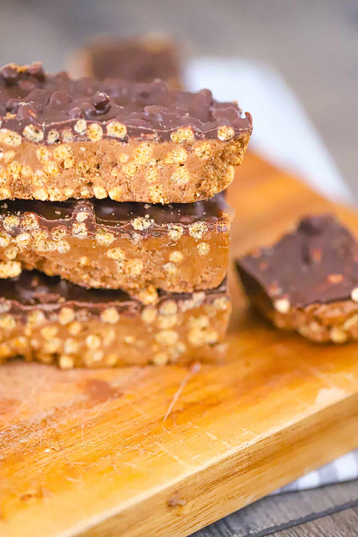 Chocolate peanut butter crunch protein bars sliced on parchment paper showing the crunchy quinoa inside