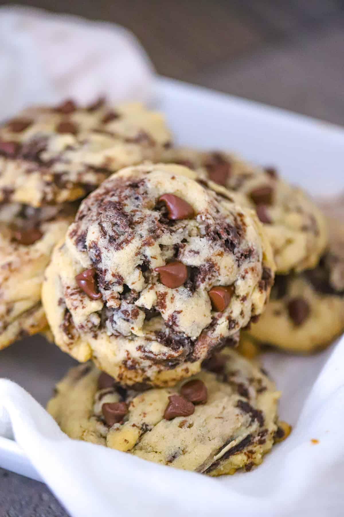 Brownie cookies with chocolate chips pressed over their warm craggy tops