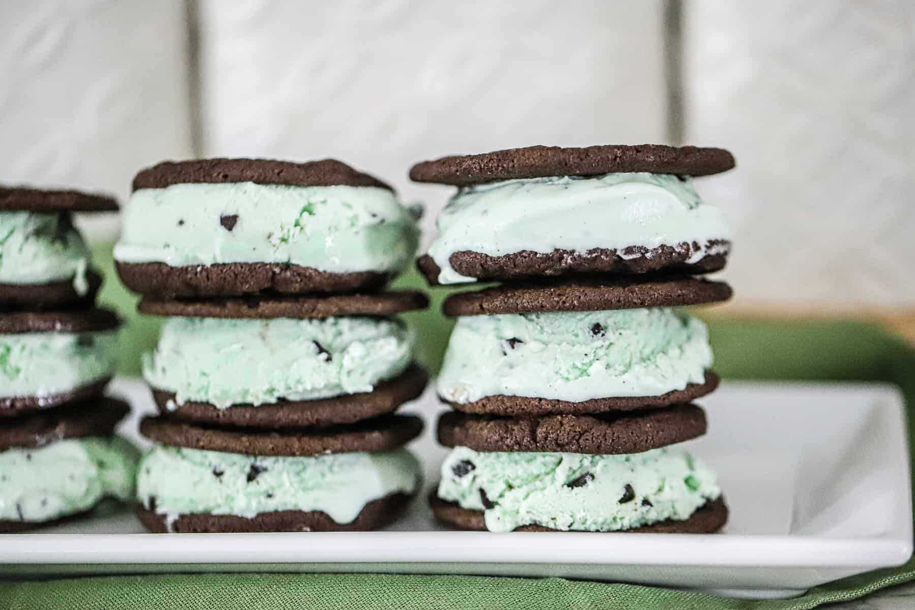 Brownie ice cream sandwiches made with thin, fudgy cookies and mint chip ice cream.