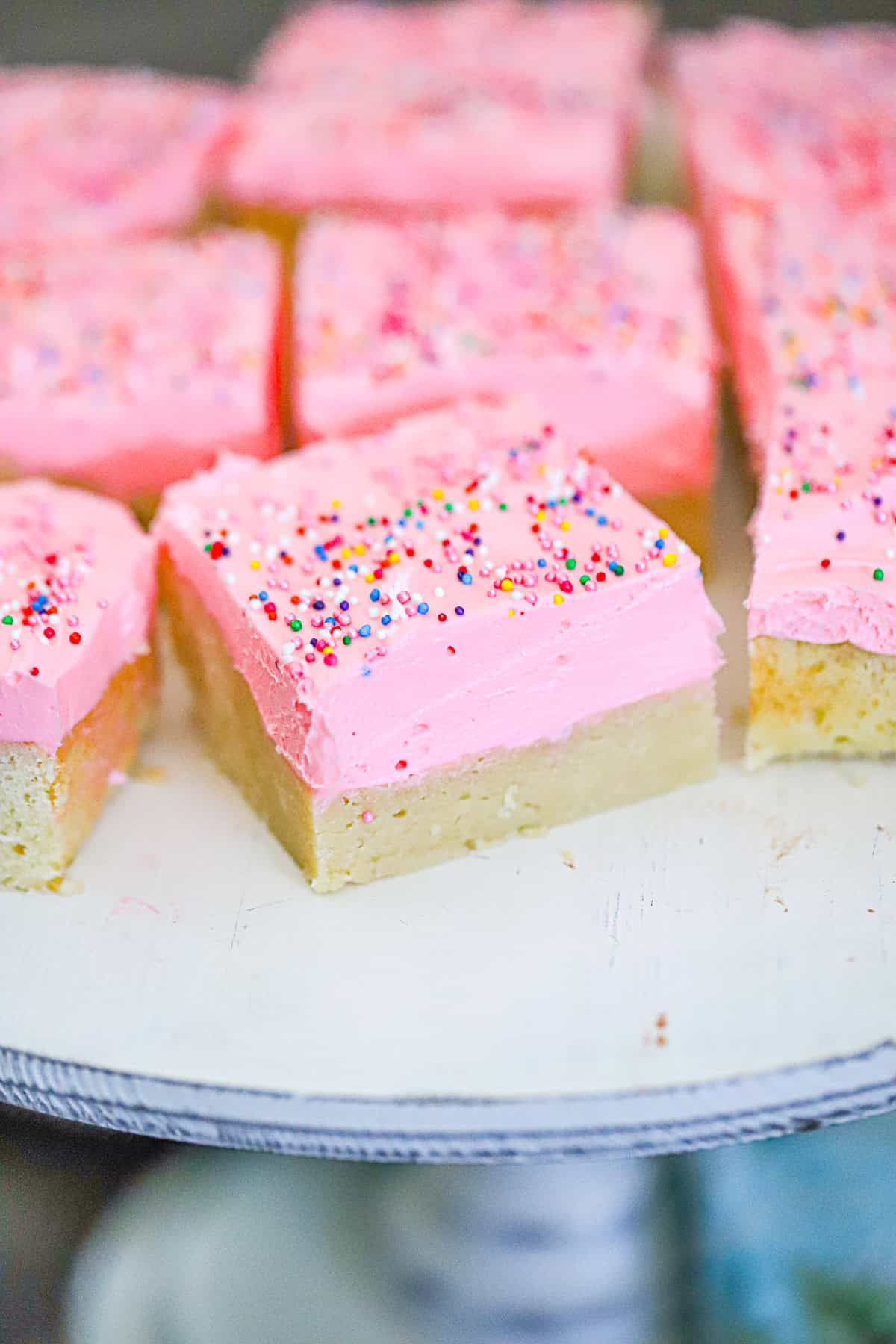 pink frosted bars topped with rainbow sprinkles ready to serve - Soft Baked Sugar Cookie Bars