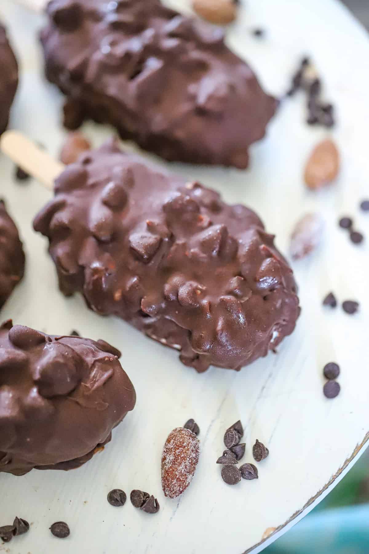 dark chocolate almond magnum bars on sticks with a cracked chocolate shell