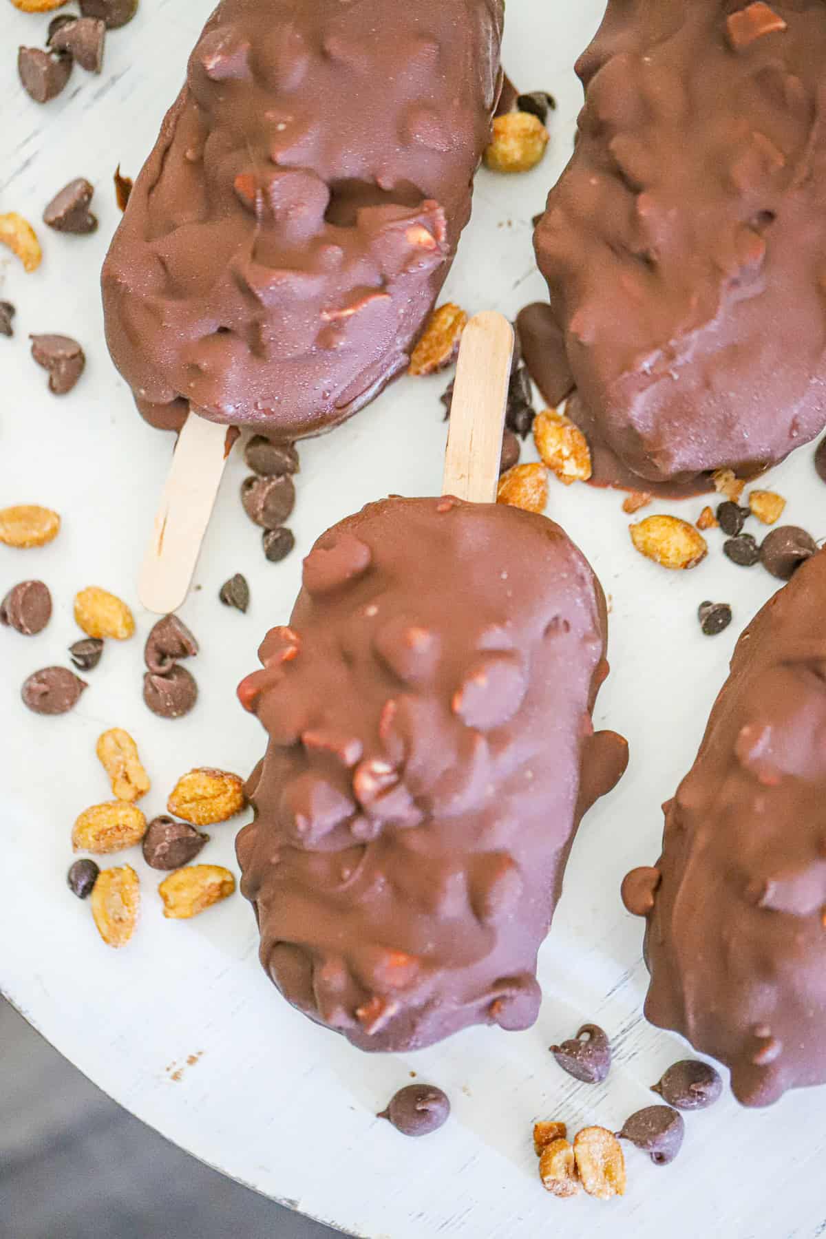 chocolate peanut butter magnum bars stacked on parchment paper