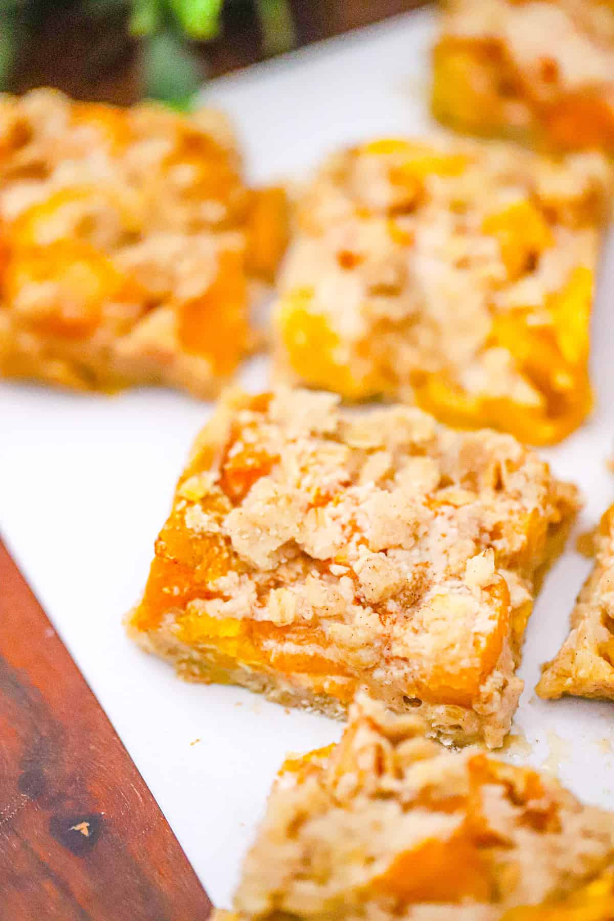 thick Peach Cobbler Cookie Bars with golden oat crumble