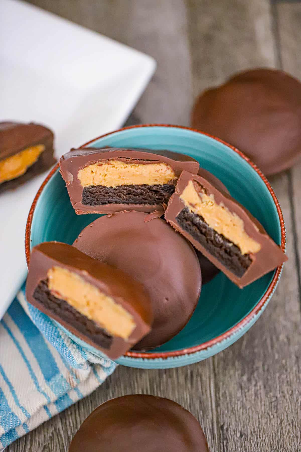 Peanut butter brownie cups coated in glossy chocolate and ready to serve