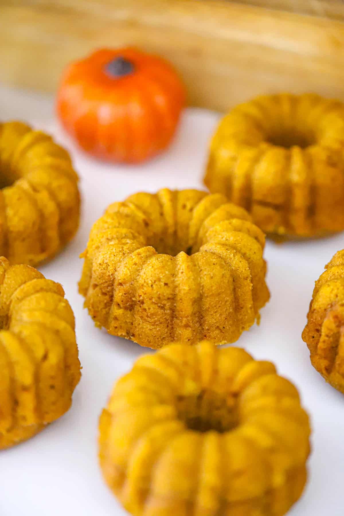 Ingredients and glazed Chai Pumpkin Mini Bundt Cakes ready to serve