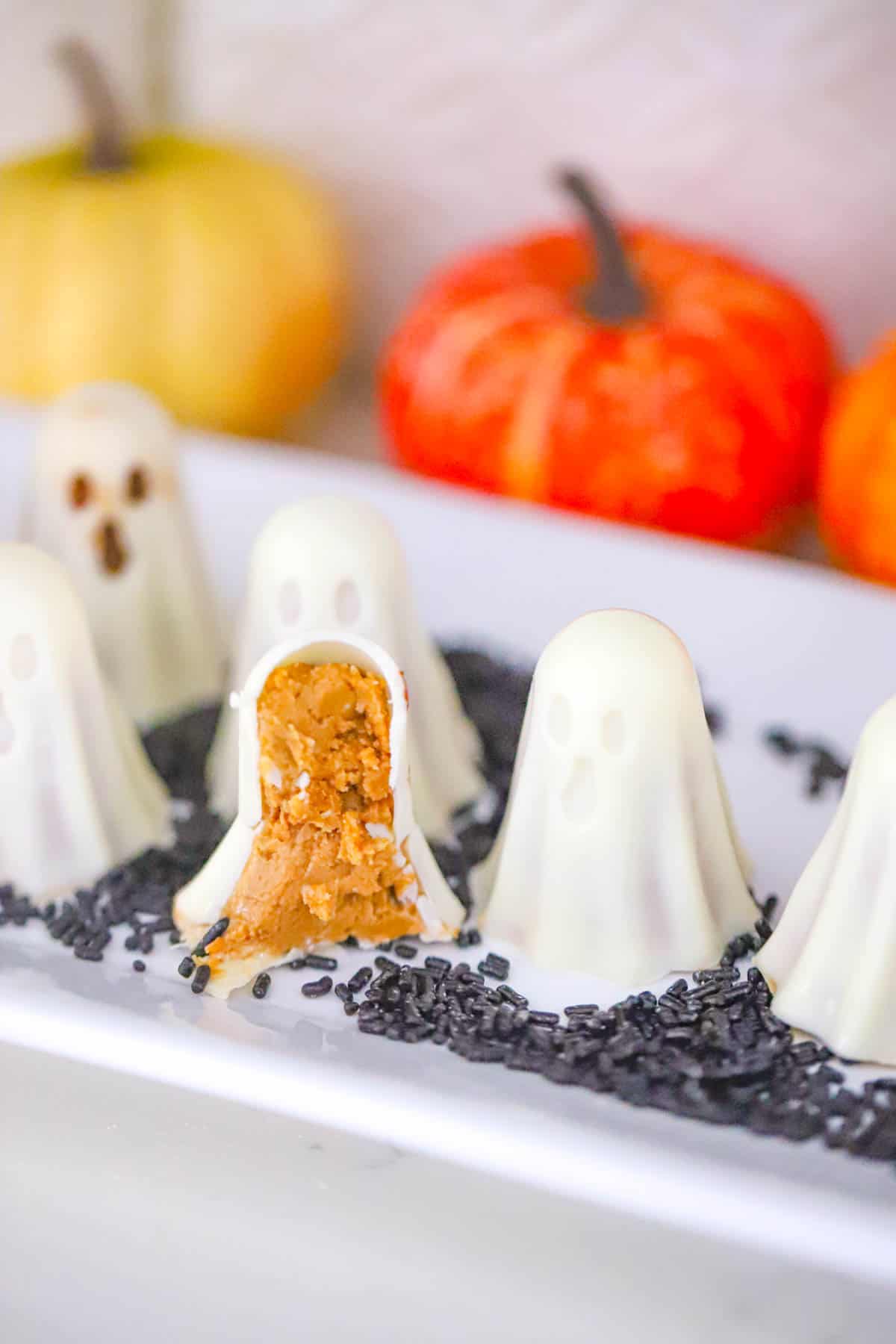 Halloween candy platter with a cut ghost revealing its golden Biscoff peanut butter center