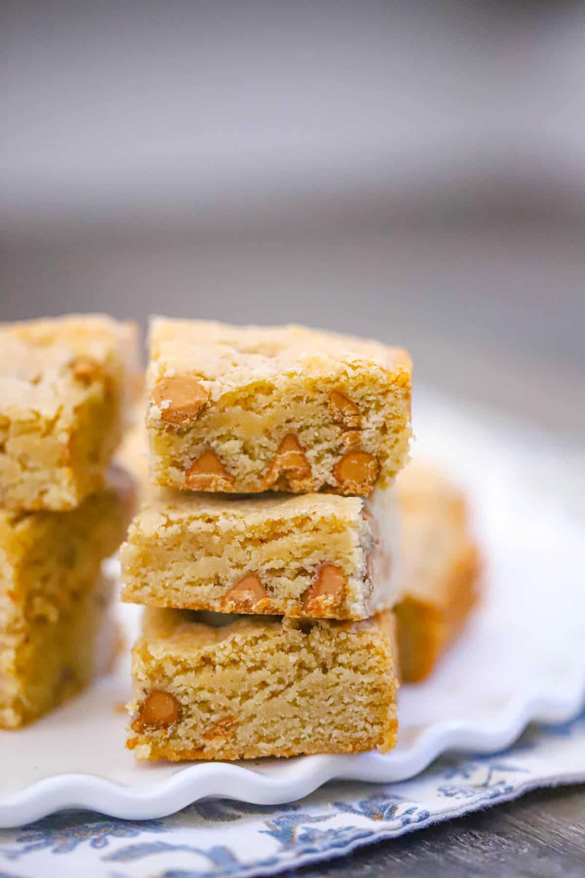 ultra thick bakery style peanut butter brownies stacked to show their fudgy centers