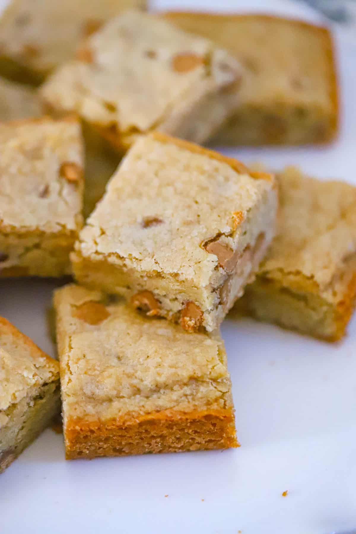 ultra thick bakery style peanut butter brownies piled high with creamy peanut butter chips