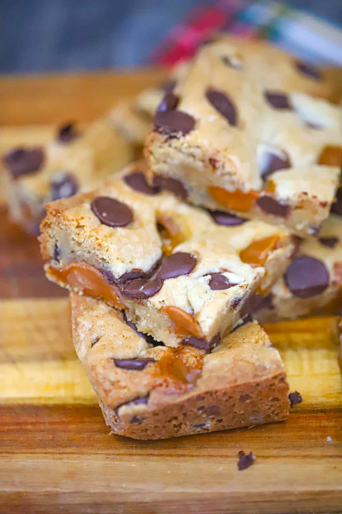 Salted Caramel Chocolate Chip Cookie Bars stacked to show the thick gooey centers
