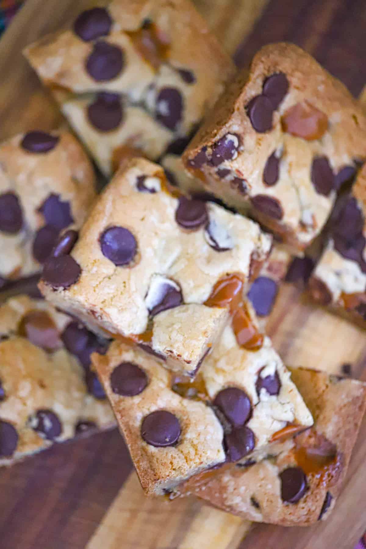 Stacked dessert squares showing thick cookie layers and a glossy caramel center