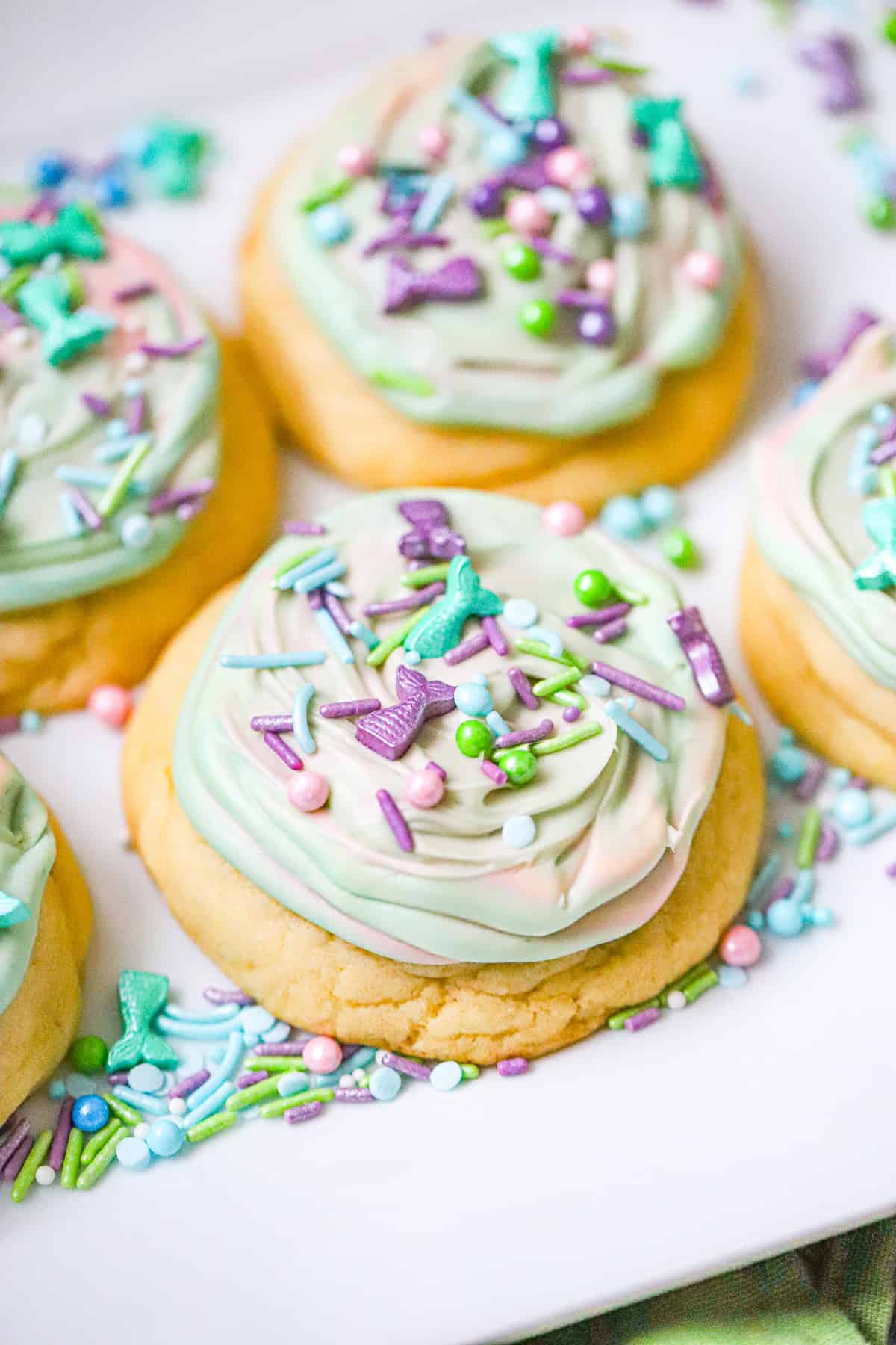 Mermaid crumbl cookies with swirled teal aqua and lavender frosting