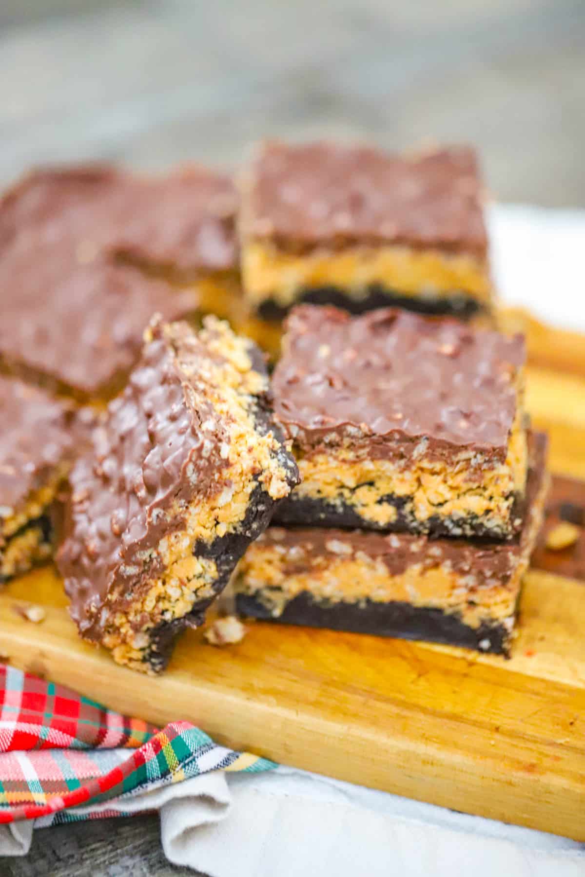 Brownie Peanut Butter Rice Krispie Bars showing the cereal layer between brownie and chocolate
