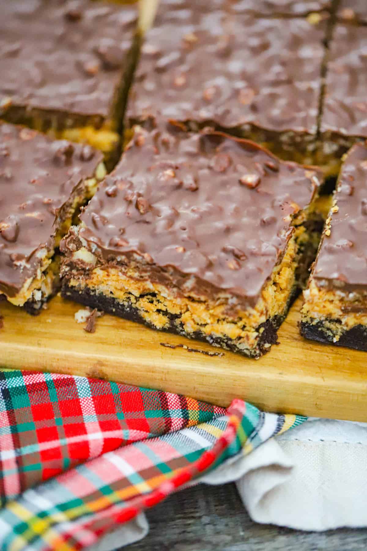 Layered dessert bars with a fudgy base and glossy chocolate top - Easy tailgating treats