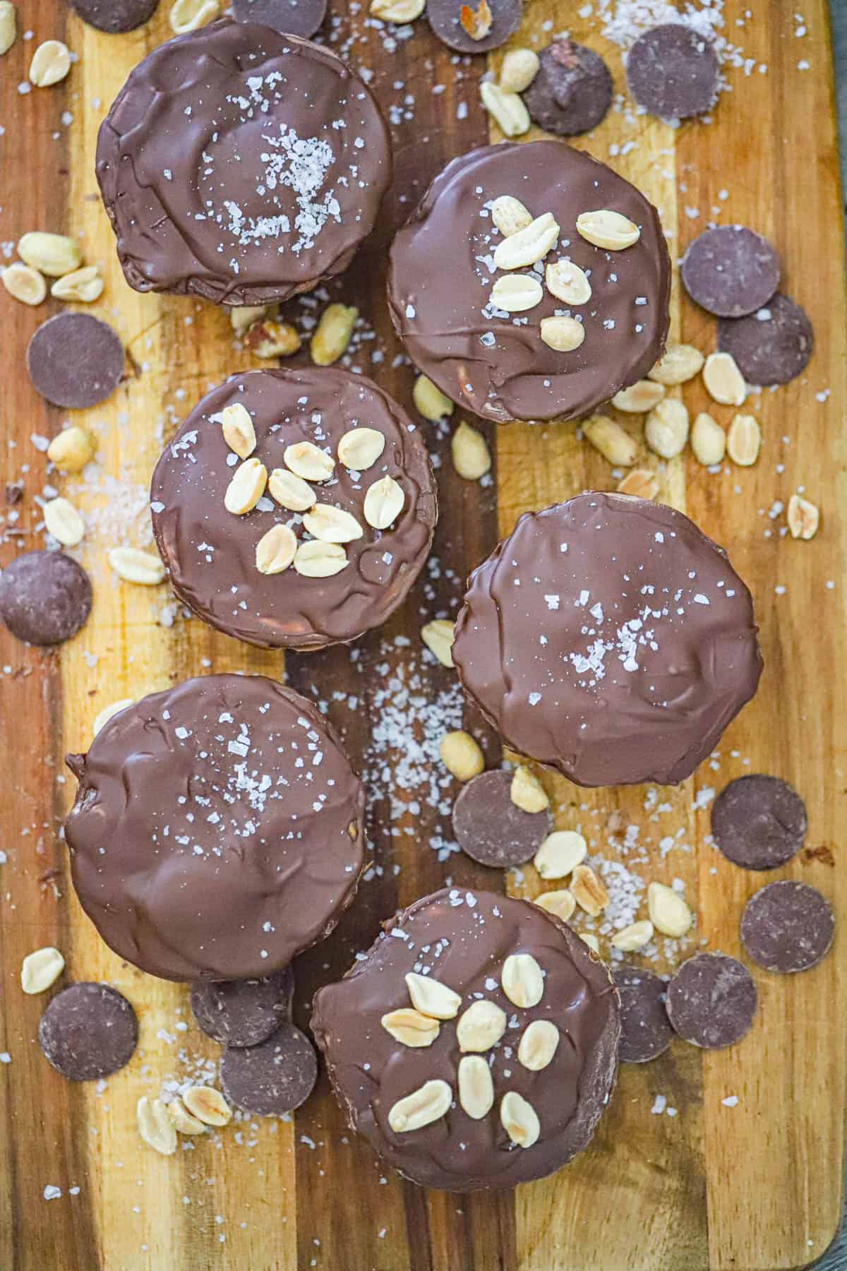 Caramel Peanut Butter Cups cut open to reveal gooey caramel and crunchy roasted peanuts