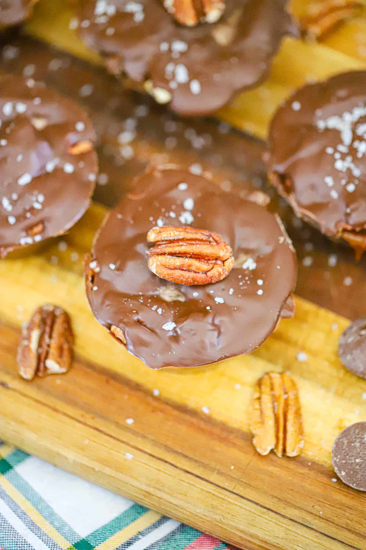 Small batch turtle Chocolate caramel brownie cups with pecans and flaky sea salt on top